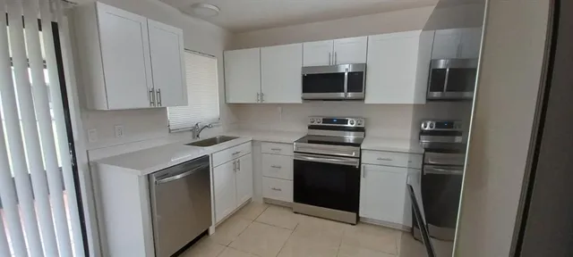 a kitchen with a refrigerator stove and microwave
