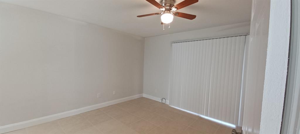 519 Southwest Sara Boulevard Port St. Lucie, FL 34953 - Photo 13 of 18 a view of a room with a fan