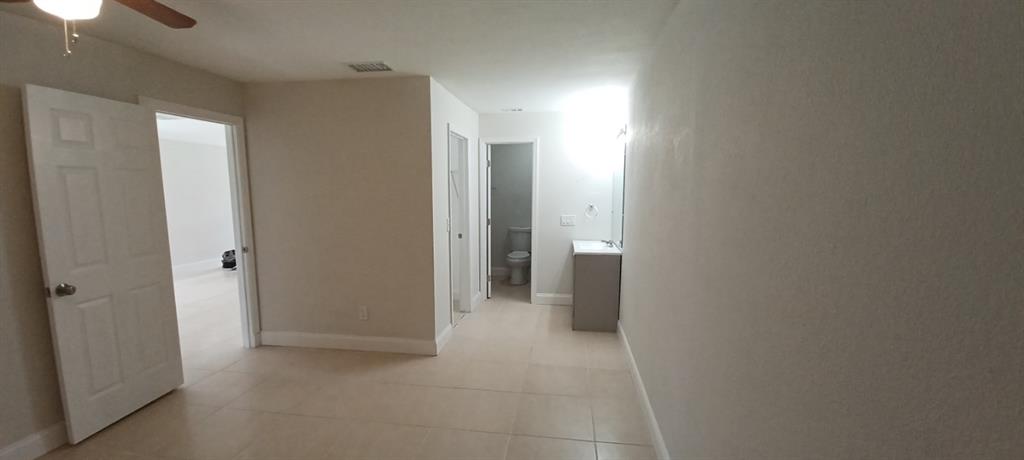 519 Southwest Sara Boulevard Port St. Lucie, FL 34953 - Photo 16 of 18 a view of a hallway with a room