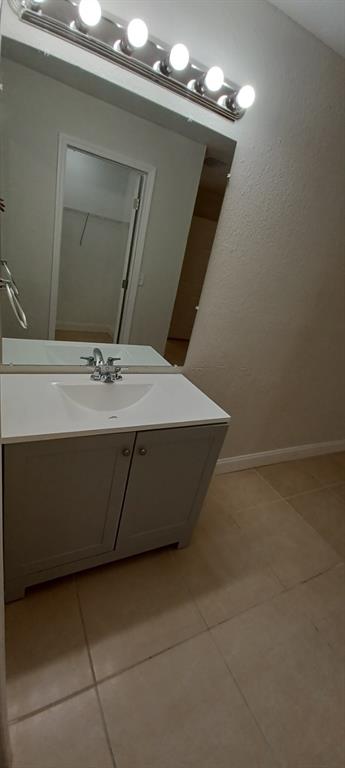 519 Southwest Sara Boulevard Port St. Lucie, FL 34953 - Photo 18 of 18 a bathroom with a sink vanity and mirror