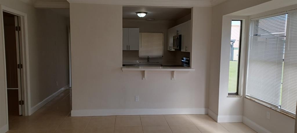 519 Southwest Sara Boulevard Port St. Lucie, FL 34953 - Photo 2 of 18 a bathroom with a sink and a mirror