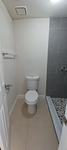 a bathroom with a toilet and a tub