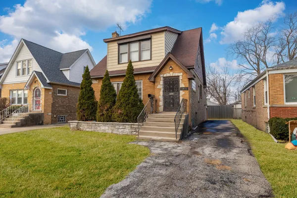 an aerial view of a house with a yard