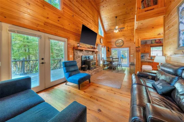 a living room with furniture fireplace and a large window