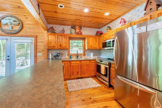 a kitchen with stainless steel appliances granite countertop a refrigerator a sink and dishwasher