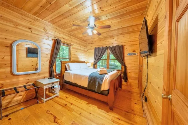 a bedroom with a bed next to a window with outer view