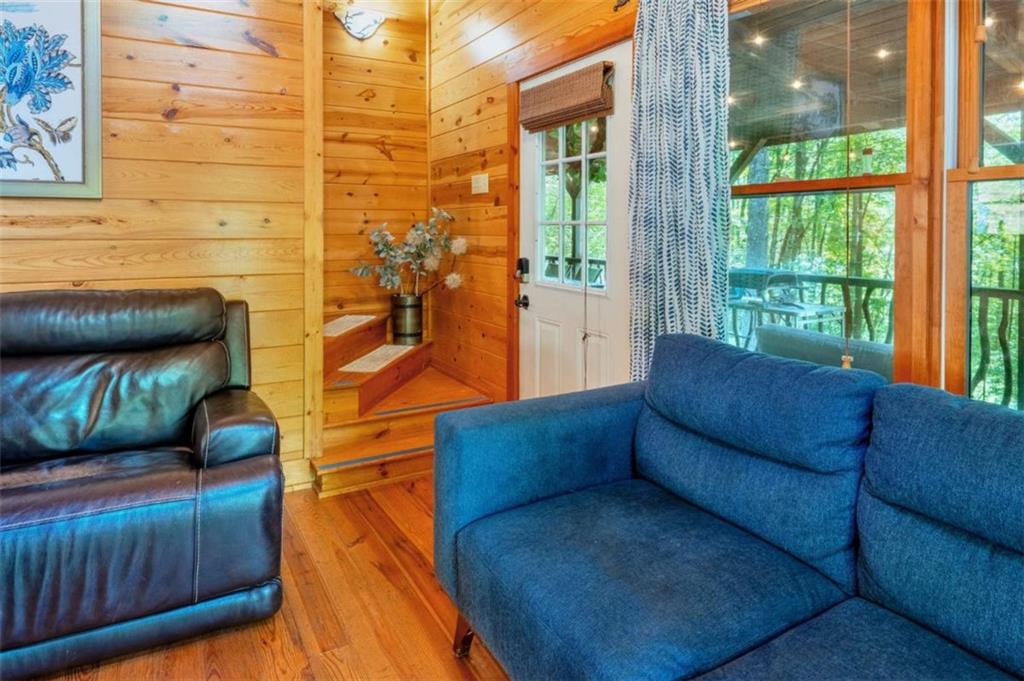 383 Canada Creek Road West Suches, GA 30572 - Photo 21 of 30 a living room with furniture and a floor to ceiling window