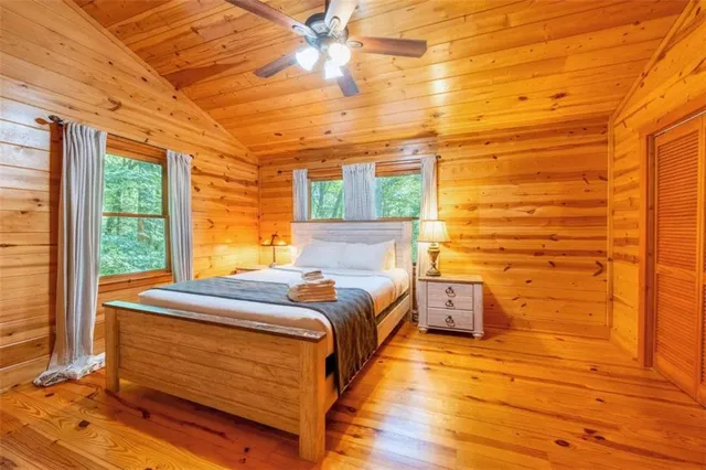 a bed room with a bed and wooden floor