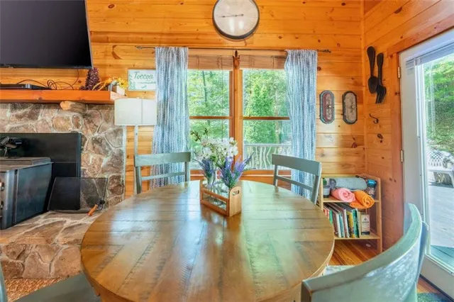 a living room with fireplace furniture and a floor to ceiling window