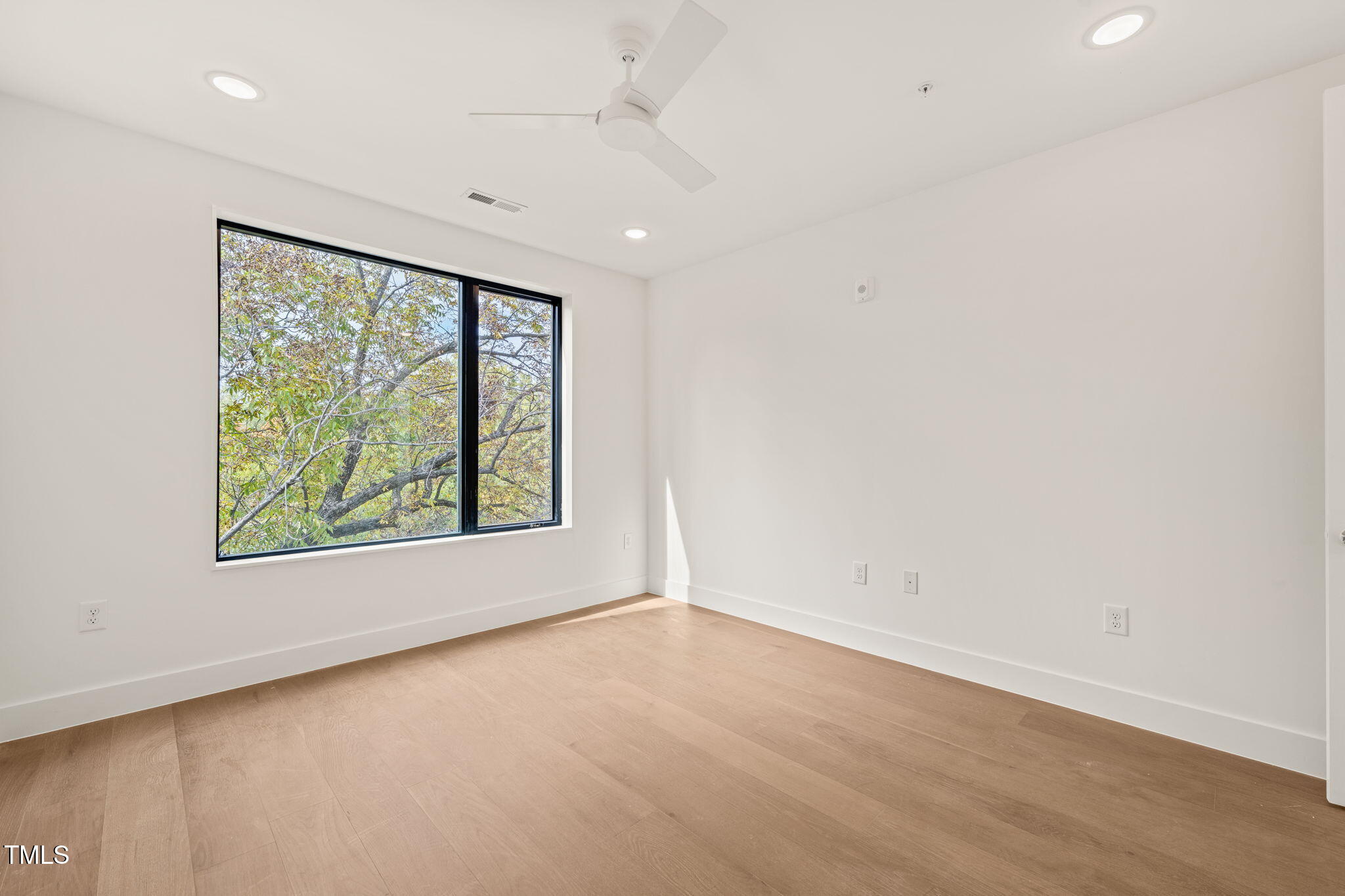 29 Enterprise Street, Unit 302 Raleigh, NC 27607 - Photo 4 of 36 an empty room with a window