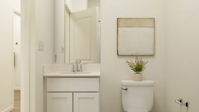 a bathroom with a sink toilet and mirror