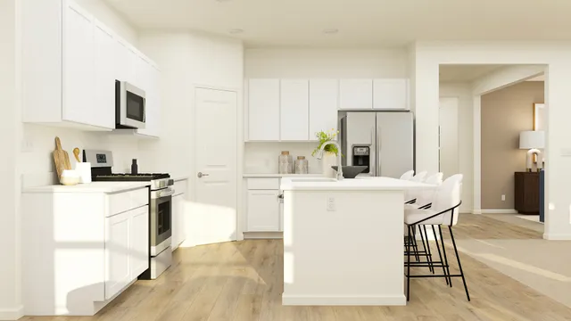 a kitchen with stainless steel appliances a stove a sink and a refrigerator