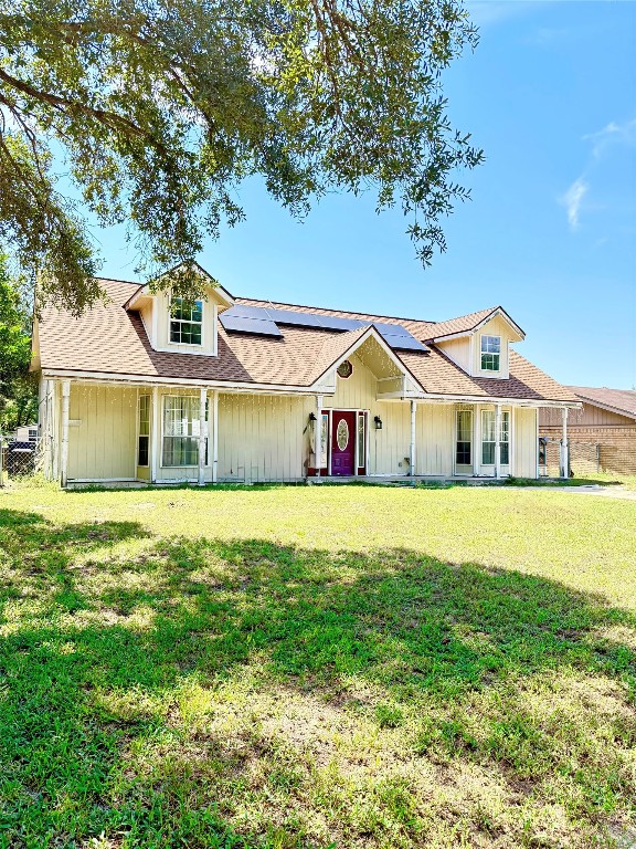 a front view of a house with a yard table and chairs
