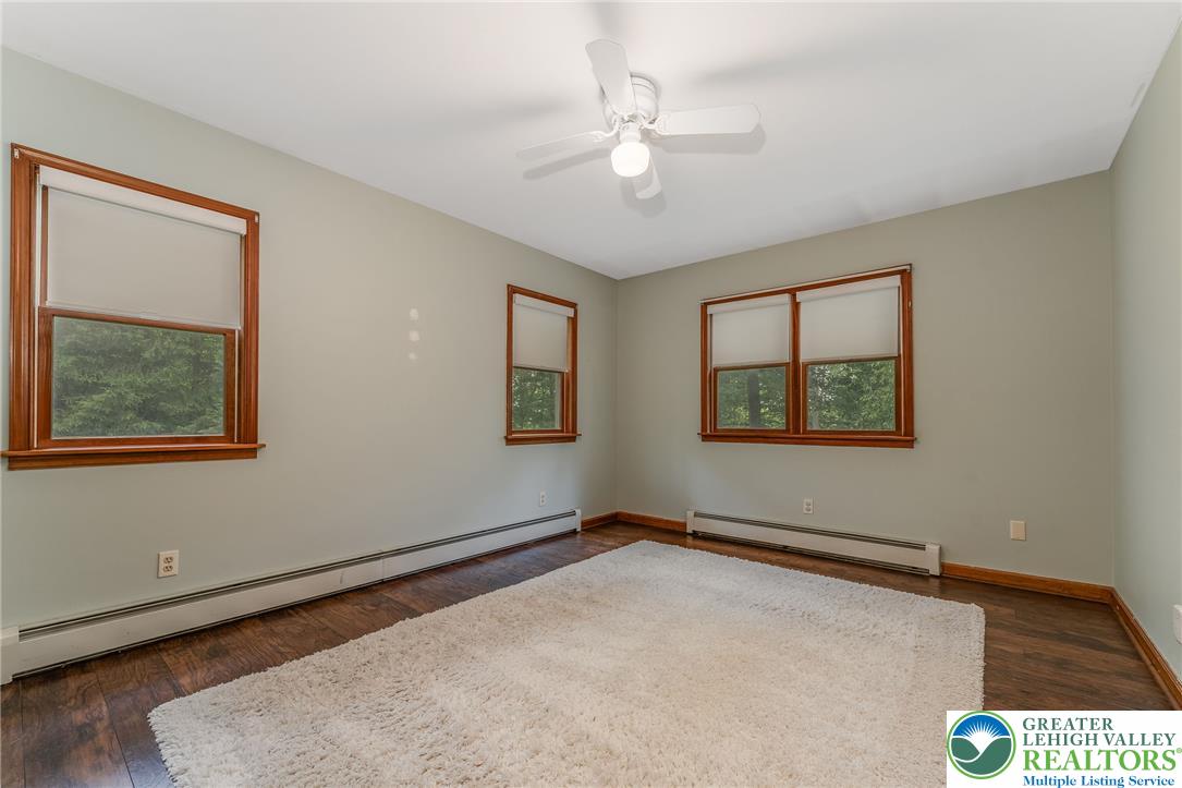 465 Raubsville Road Easton, PA 18042 - Photo 29 of 60 1st floor Primary bedroom. Well-lit sleeping quarters with a comforting ceiling fan.