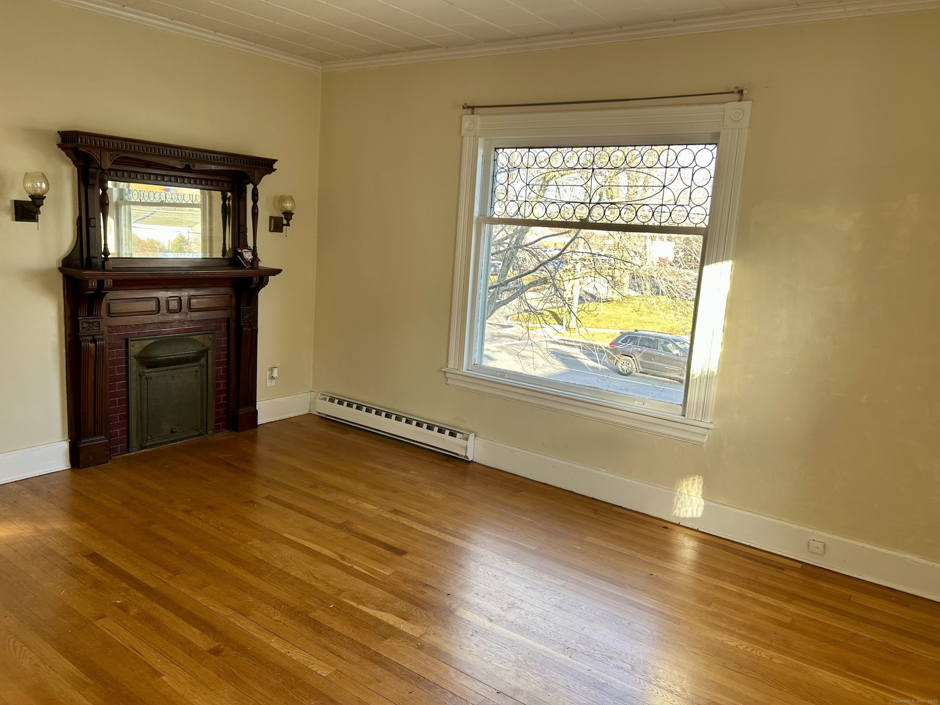 2247 Main Street, Unit 2 Glastonbury, CT 06033 - Photo 5 of 13 Cozy room with a view includes a decorative fireplace.