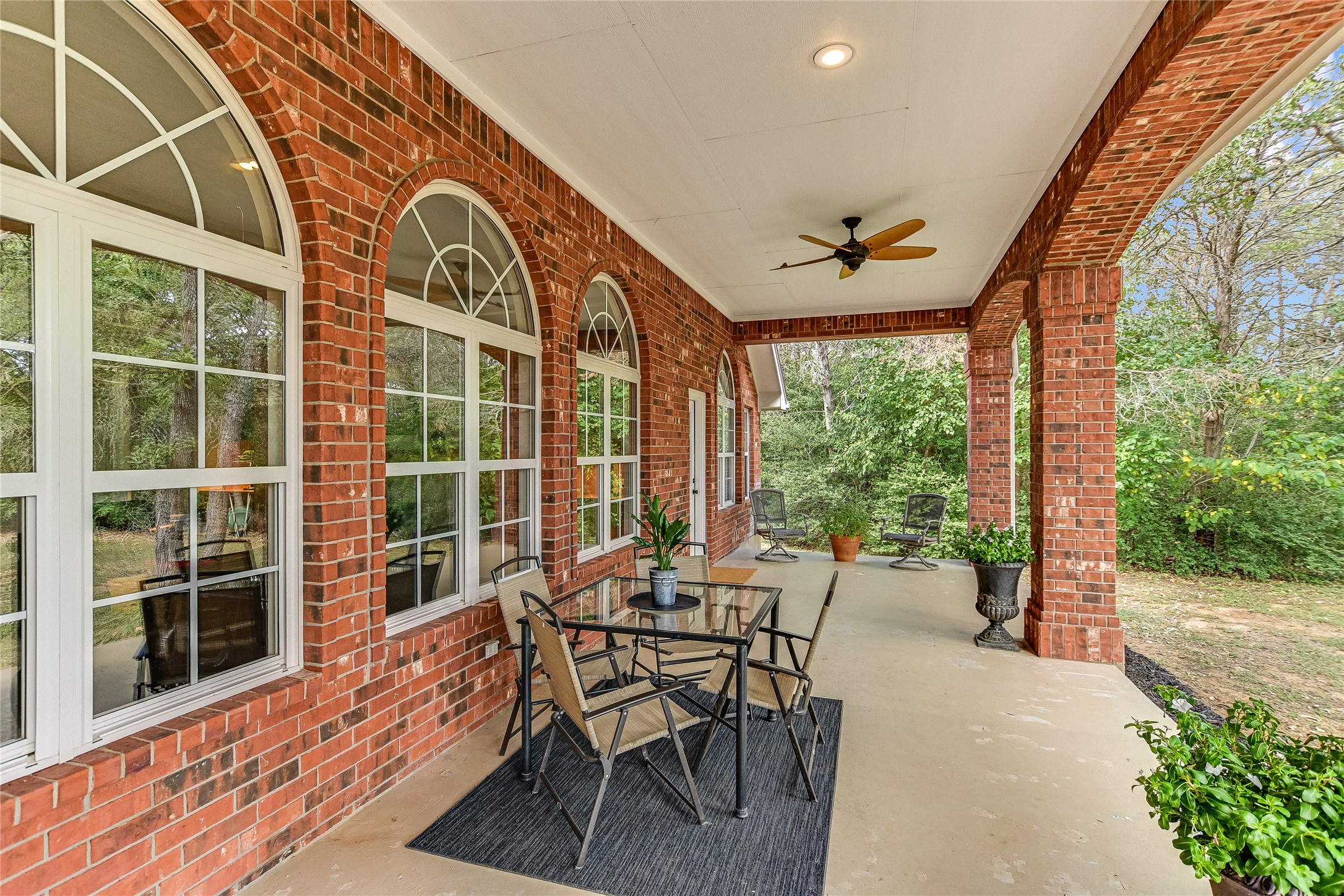 741 Knobbs Road McDade, TX 78650 - Photo 25 of 38 An inviting covered patio featuring robust brick columns, ideal for serene outdoor relaxation.