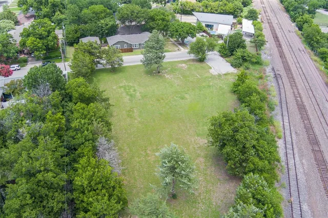 an aerial view of residential house with outdoor space and trees all around