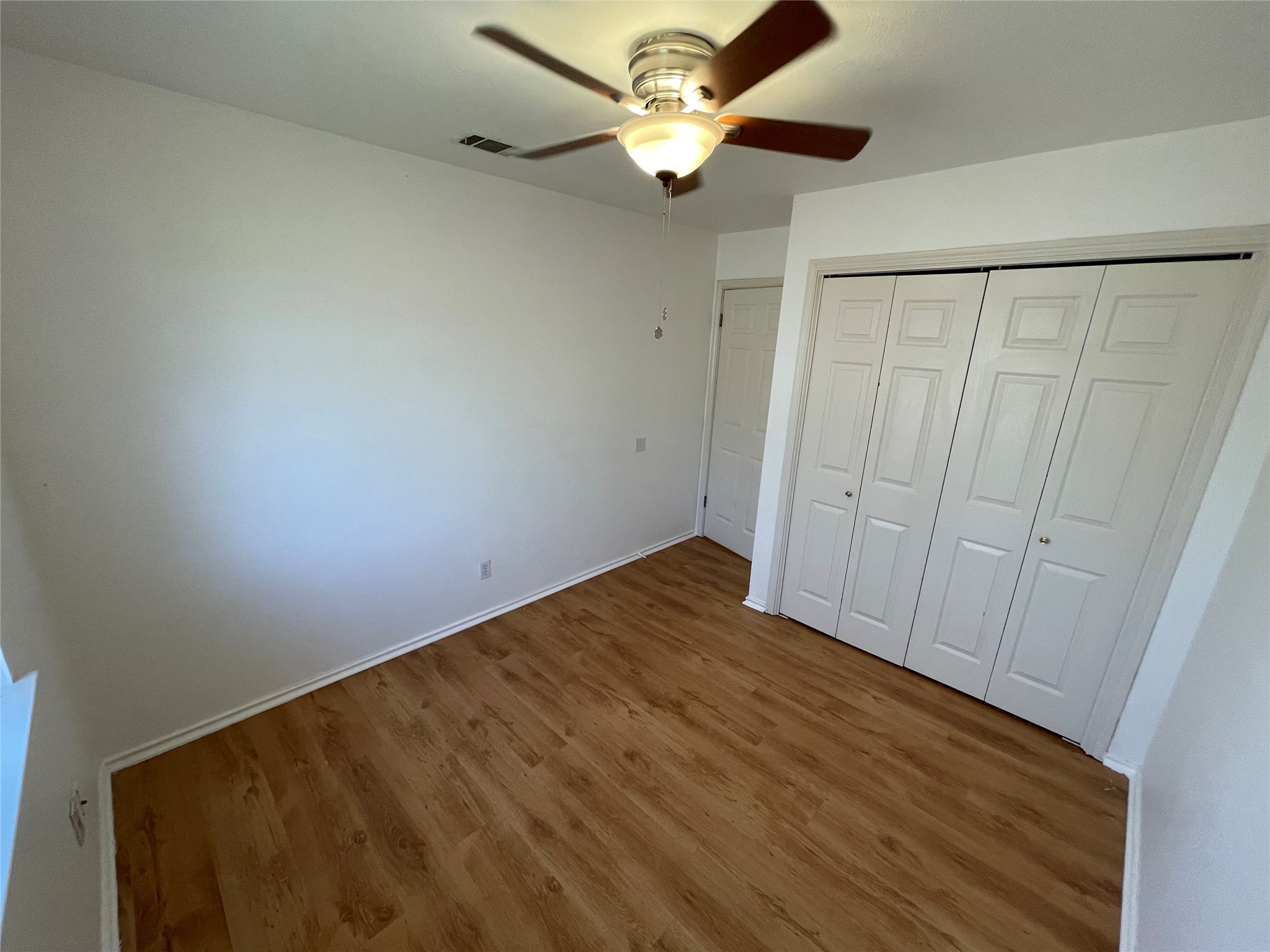 8010 Willet Trail, Unit A Austin, TX 78745 - Photo 19 of 31 a view of empty room with a ceiling fan and wooden floor