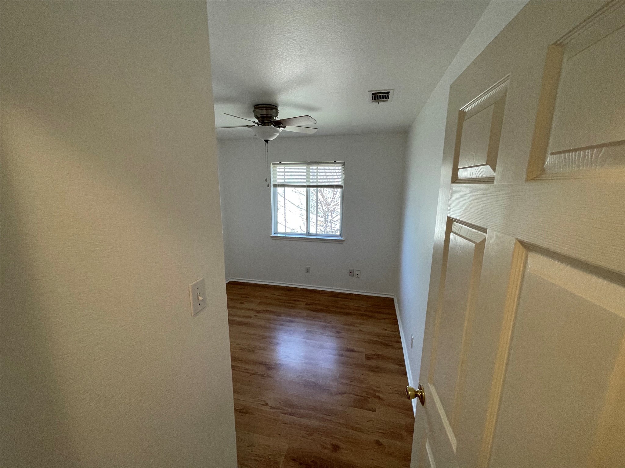 8010 Willet Trail, Unit A Austin, TX 78745 - Photo 22 of 31 a view of empty room with window and wooden floor