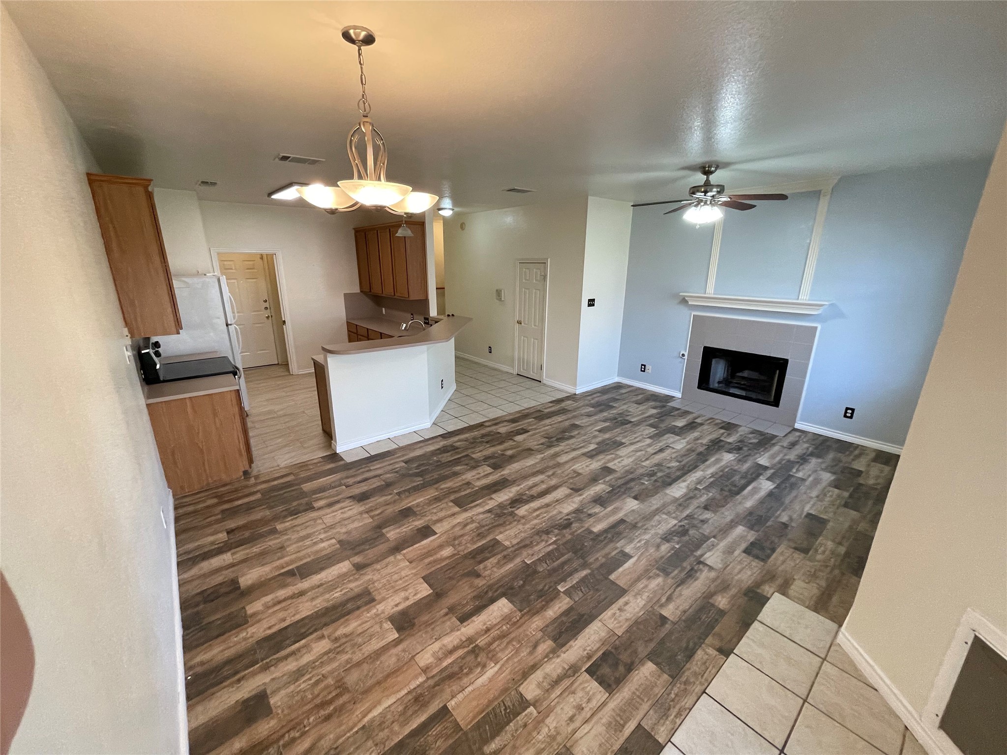 8010 Willet Trail, Unit A Austin, TX 78745 - Photo 4 of 31 a view of a livingroom with a fireplace a chandelier wooden floor and chandelier