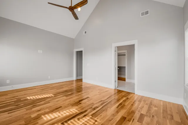 a view of walk in closet with empty racks
