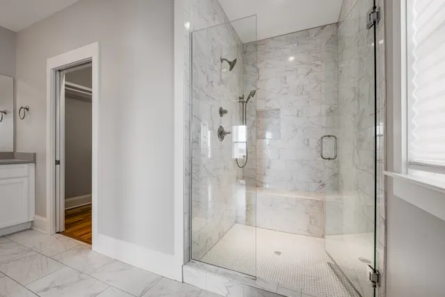 a bathroom with a sink a toilet a mirror a bathtub and shower