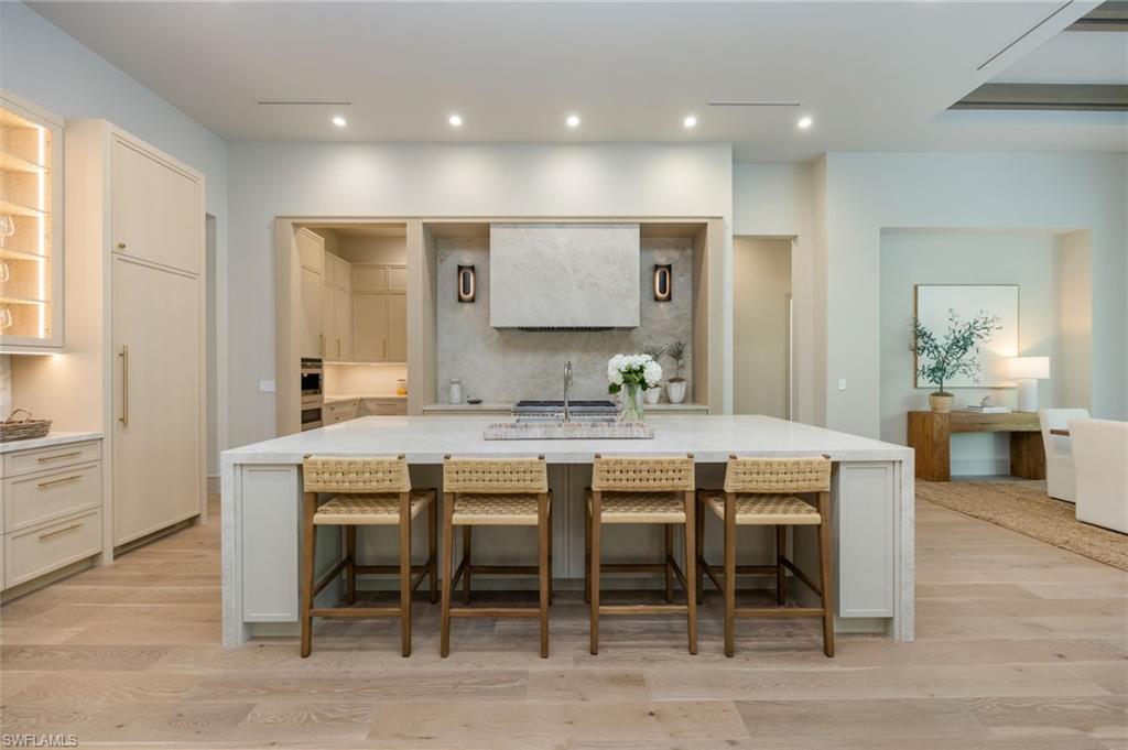 4851 Crayton Road Naples, FL 34103 - Photo 9 of 33 a room with stainless steel appliances kitchen island granite countertop furniture and a dining table