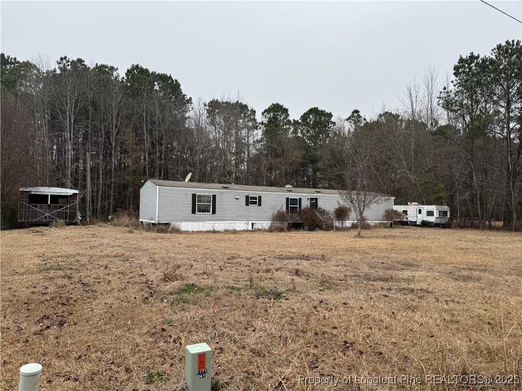 a big house with a big yard and large trees
