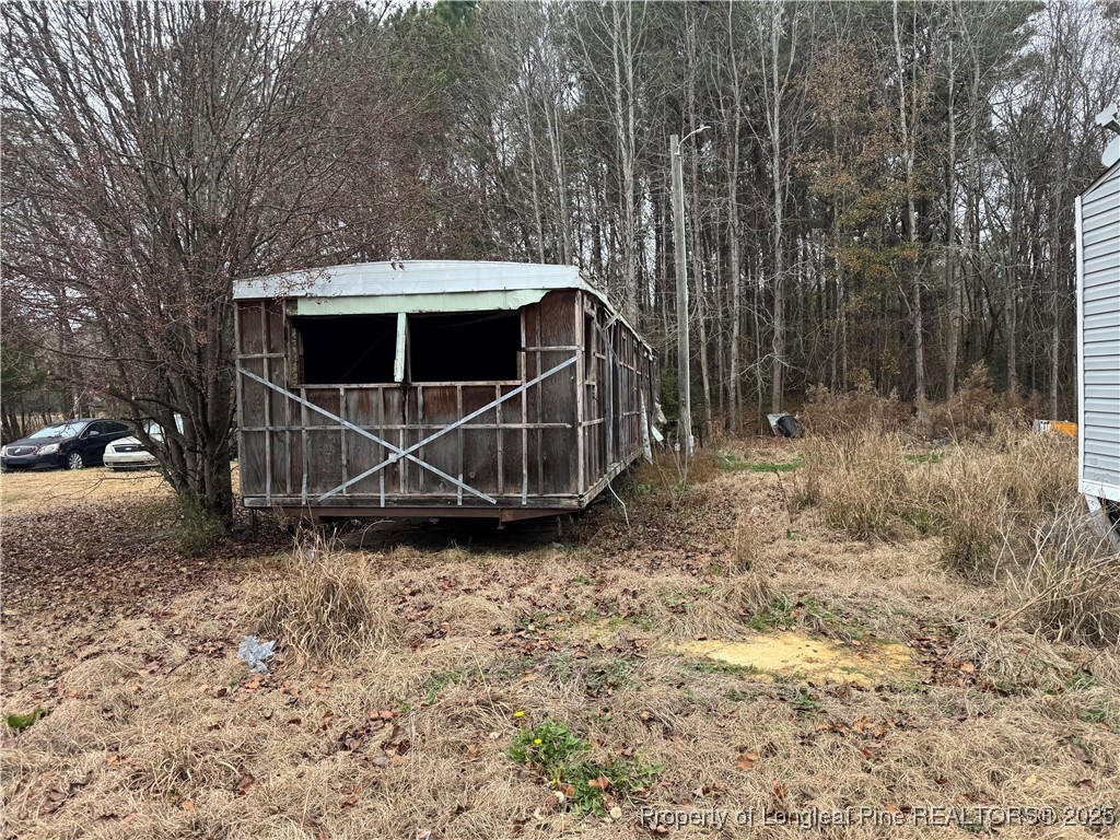 2692 Jonesville Road Fairmont, NC 28340 - Photo 3 of 9 a view of a tiny house with a yard
