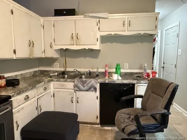 a kitchen with stainless steel appliances kitchen island granite countertop a sink and cabinets