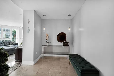 a living room with furniture a flat screen tv and a large window