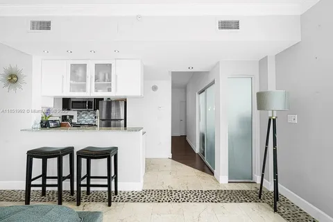 a kitchen with stainless steel appliances granite countertop a refrigerator and a stove