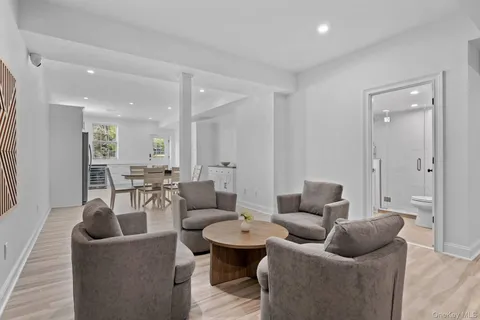 a living room with furniture and a view of bathroom