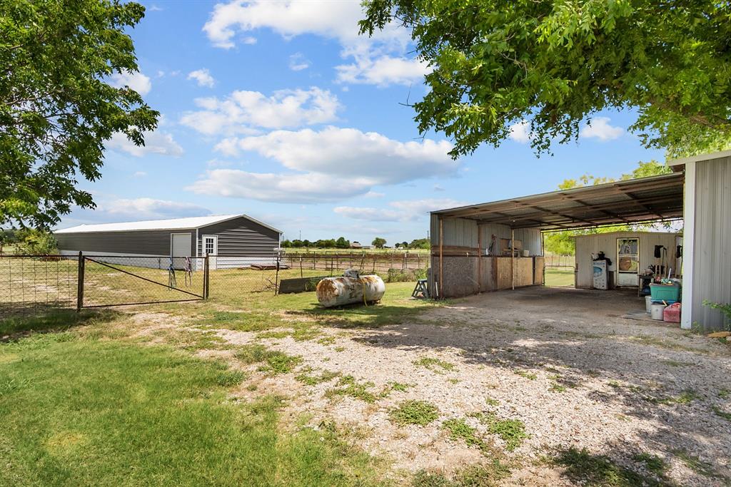 87 Ledbetter Road Mineral Wells, TX 76067 - Photo 13 of 22 a view of a house with a yard and sitting area