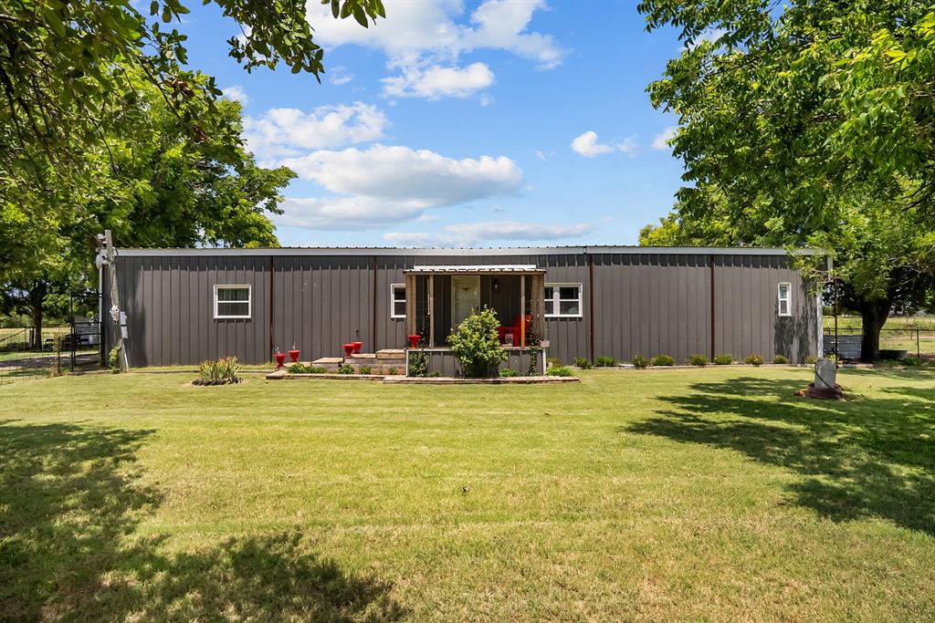 87 Ledbetter Road Mineral Wells, TX 76067 - Photo 3 of 22 a view of a house with a backyard and a tree