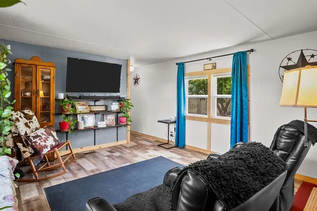 a bedroom with bed and a flat screen tv
