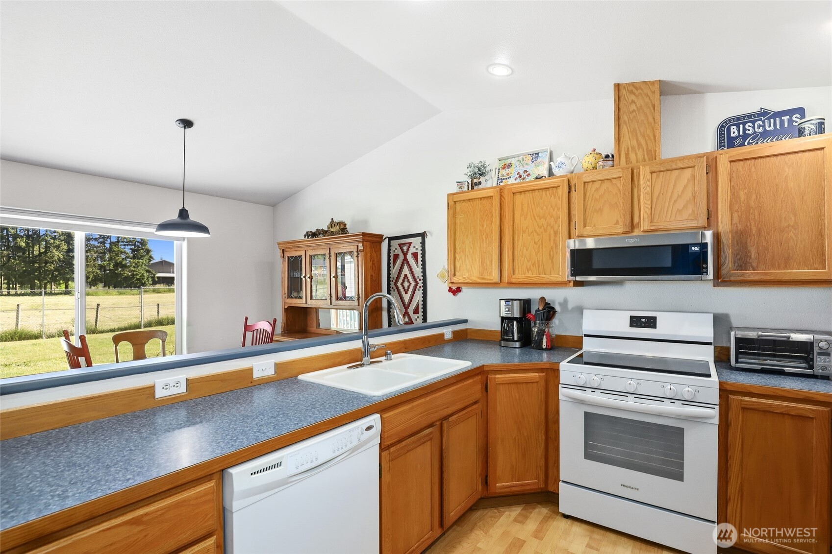 8008 188th Avenue Southwest Rochester, WA 98579 - Photo 15 of 40 a kitchen with stainless steel appliances a sink a stove and a window