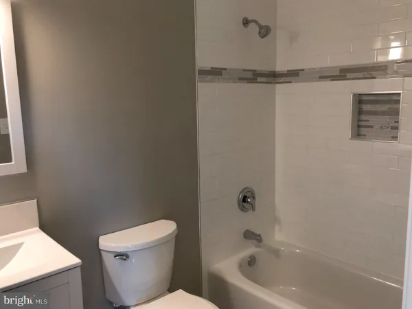 a bathroom with a sink toilet and mirror