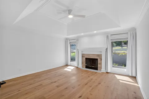 wooden floor fireplace and windows in a room