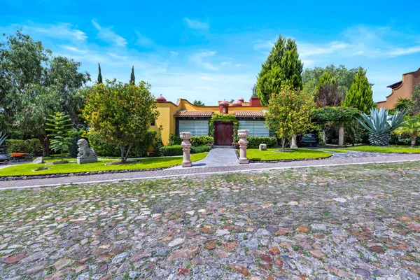 a view of a house with swimming pool and a yard