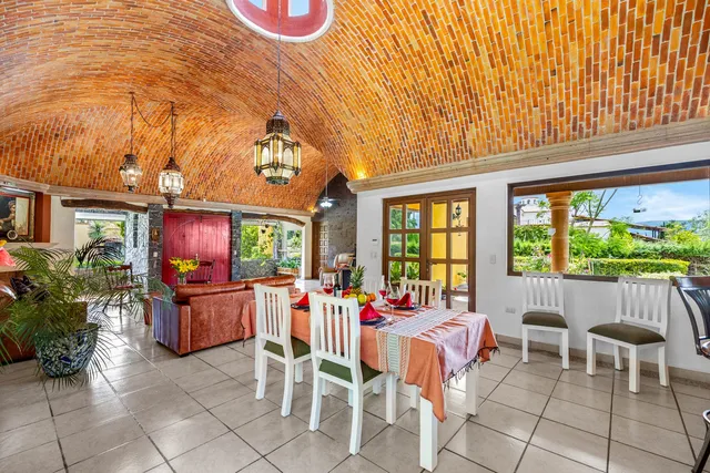 a living room with furniture a window and a dining table