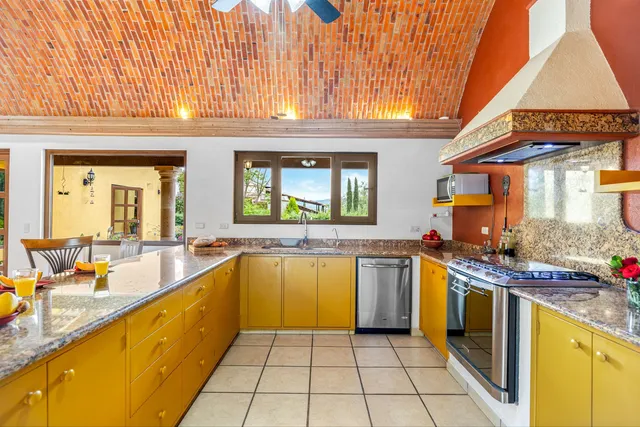 a kitchen with a sink a stove and cabinets