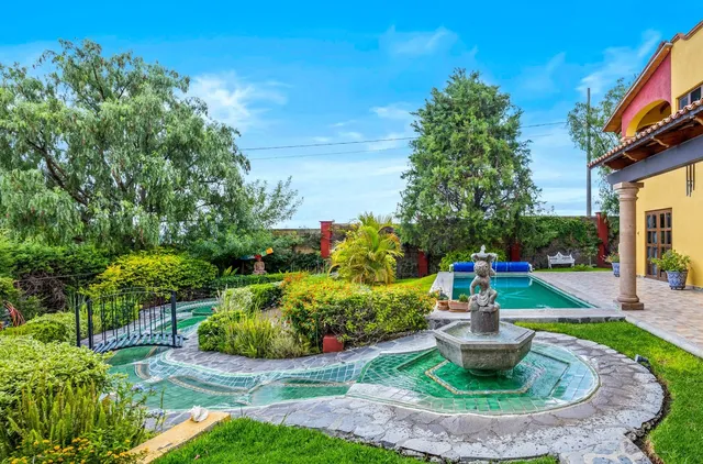 a view of a house with a garden and plants