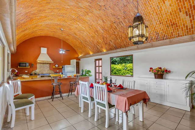 a dining room with furniture a window and stainless steel appliances