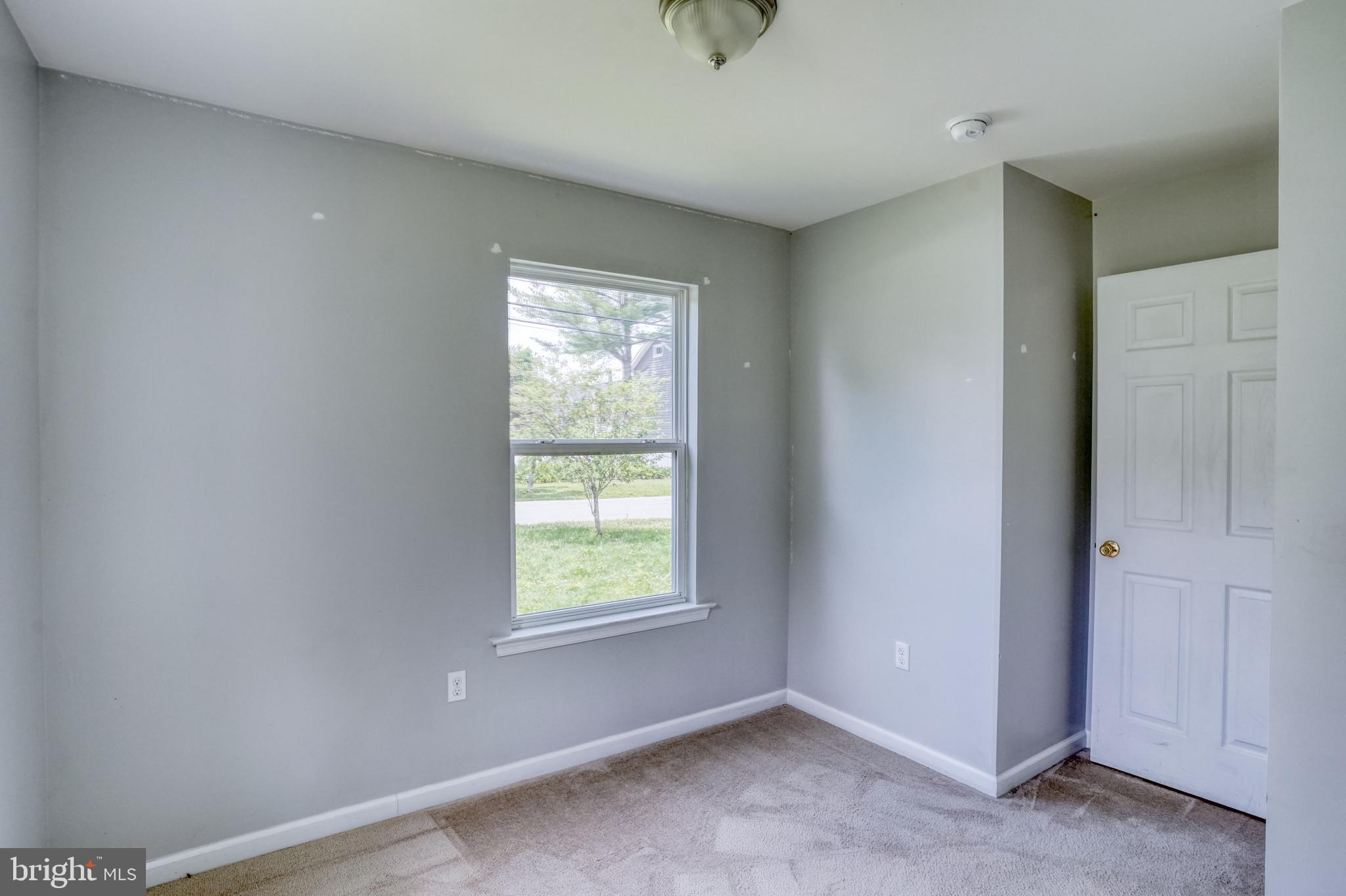203 Hamilton Street Delaware City, DE 19706 - Photo 15 of 27 a view of an empty room with a window
