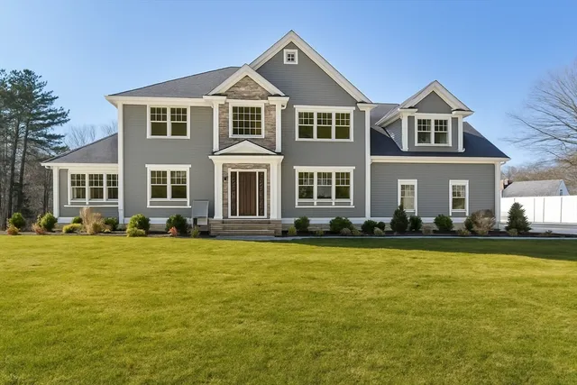 a front view of a house with a yard