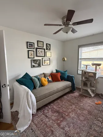 a living room with furniture and two window