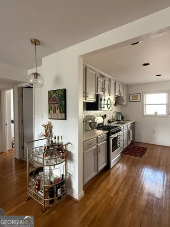 a kitchen with a sink cabinets and wooden floor