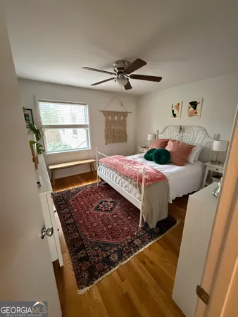 a bed sitting in a bedroom next to a window