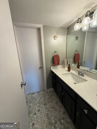 a bathroom with a double vanity sink and mirror